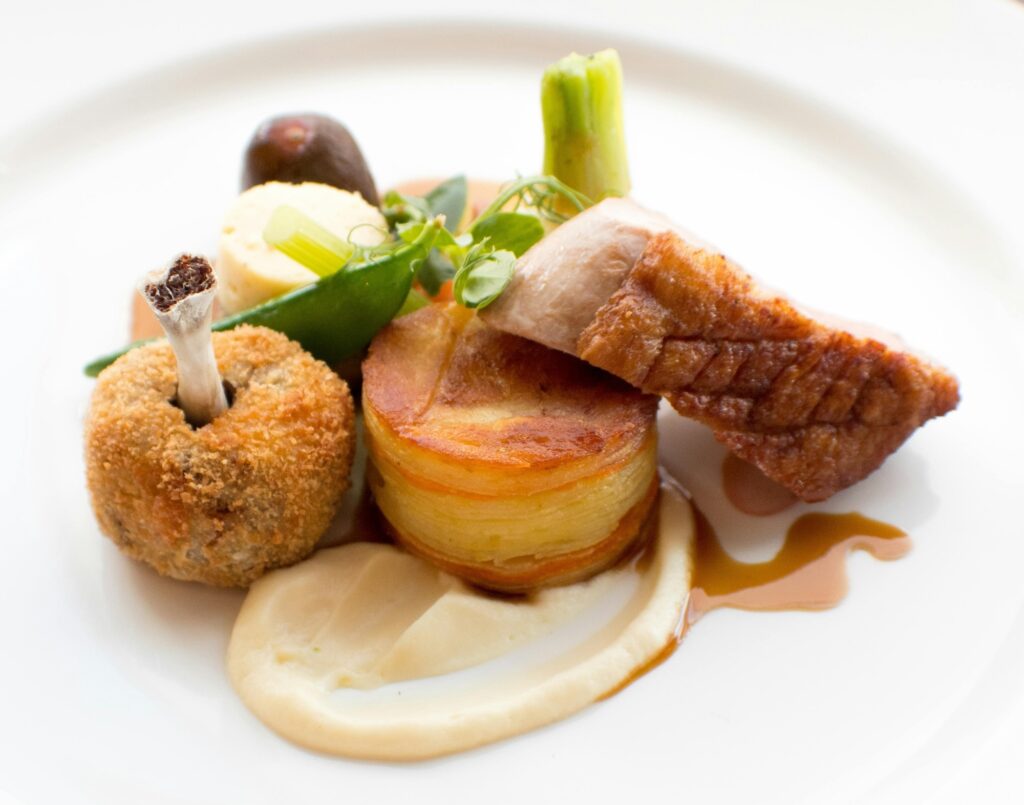 Gourmet lamb dish plated elegantly in a Michelin-starred restaurant, paired with fine Italian wine for Easter.